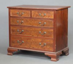A Georgian style bleached mahogany chest of 2 short and 3 long graduated drawers, raised on