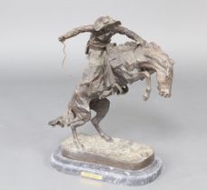 After Frederic Remington, a bronze figure "Bronco Buster" 61cm h x 50cm w x 28cm d, raised on an