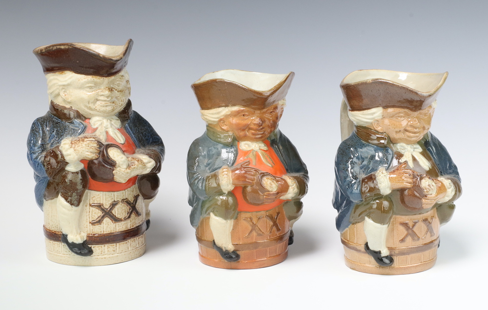 Three graduated Royal Doulton Lambeth pottery Toby jugs of Toby Philpott astride a barrel marked