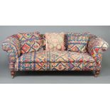 A Victorian Chesterfield upholstered in Kilim style material, raised on turned supports 70cm h x