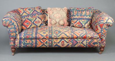 A Victorian Chesterfield upholstered in Kilim style material, raised on turned supports 70cm h x