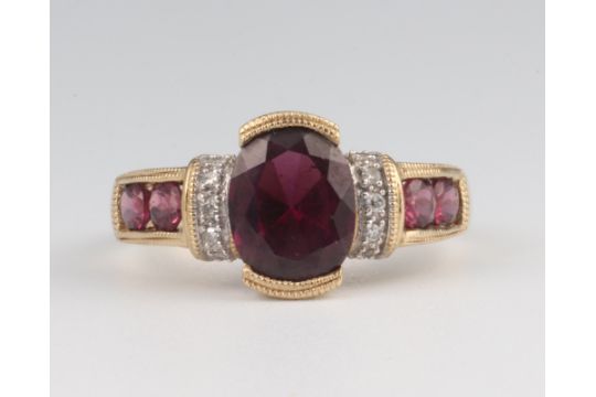 A yellow metal 9k garnet and diamond ring 3.5 grams, size N