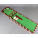 A 19th Century mahogany table top bagatelle 5cm h x 216cm l x 51cm w, complete with cue and balls