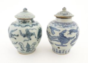 Two Chinese blue and white lidded jars / vases decorated with stylised phoenix birds in flight.