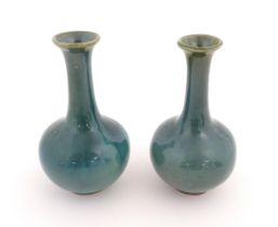 A pair of Chinese bottle vases with flared rim in a blue glaze. Approx. 5 3/4" high (2) Please