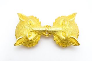 A gilt metal two part belt buckle with fox head detail by Paquette. Approx. 3 1/2" wide overall