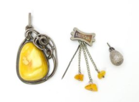 Three items of jewellery to include a Polish silver pendant set with amber cabochon, a Lithuanian