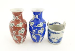 A Chinese blue a white model of a pail with floral decoration. Together with two vases decorated