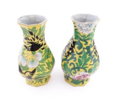 Two Chinese vases of octagonal form with a yellow ground decorated with flowers and foliage. Approx.