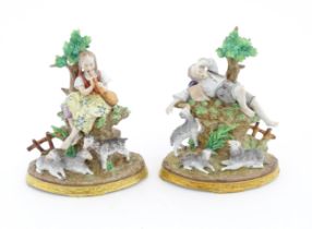 A pair of Sitzendorf figural groups, comprising a sleeping shepherd with lambs and a shepherdess