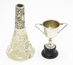 A miniature silver twin handled trophy cup hallmarked Birmingham 1934, maker William Adams Ltd.