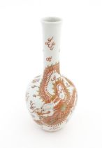 A Chinese bottle vase decorated with a dragon, flaming pearl, stylised clouds and waves. Character