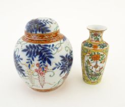 A Chinese vase with a yellow ground decorated with flowers and foliage. Together with a Chinese