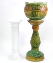 A majolica jardiniere stand and planter with foliate decoration, signed England. Together with a