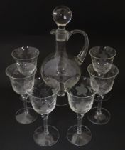 A 20thC glass decanter with etched fruiting detail. Together with six matching drinking glasses.