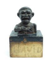 A cast iron novelty money box / piggy bank titled 'Little Joe Bank'. Mounted on a wooden box.