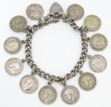 A silver bracelet set with various George V and Edward VI coins Please Note - we do not make