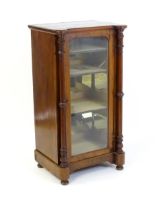 A late 19thC / early 20thC music cabinet of larger proportions, having a castellated front edge, two
