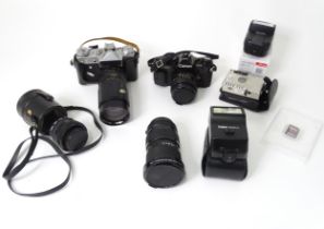 A quantity of cameras and camera / photograph equipment to include a Canon AE-1, a Zenit E with