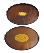 A Victorian mahogany tray of oval form with scalloped edge gallery, twin brass handles and inlaid