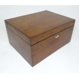 A 20thC mahogany box opening to reveal a tray within. Approx. 7" high x 14" wide x 10 1/2" deep