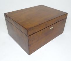 A 20thC mahogany box opening to reveal a tray within. Approx. 7" high x 14" wide x 10 1/2" deep