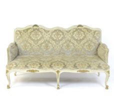 A 20thC Louis XV style sofa with carved flower and shell decoration raised on five cabriole legs.