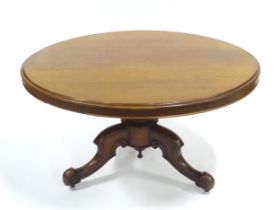 A Victorian mahogany tilt-top breakfast table, the circular top supported by a turned baluster above