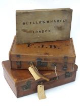 Two mid 20thC leather and brass suitcases, together with a Butler's Wharf Ltd of London shipping box