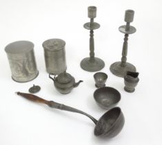 A quantity of pewter items to include a pair of candlesticks, ladle, pot and cover, teapot of