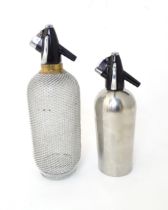 Two mid to late 20thC soda siphons, the larger example with glass bottle and wire mesh cover, approx