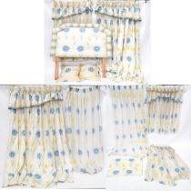 A quantity of bedroom soft furnishings decorated with blue and yellow flowers to include curtains,