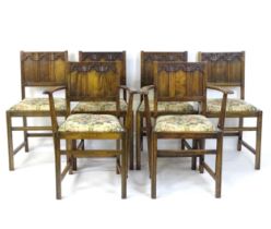 A set of six early / mid 20thC oak and elm Gothic Ercol style dining chairs. The armchairs measuring