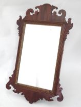 A 20thC Georgian style wall mirror, with carved mahogany frame. Approx. 25 1/2" high overall