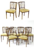 A set of eight modern dining chairs with pierced back splats and raised on canted tapering front