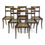 A set of six 19thC brass inlaid dining chairs, with caned seats and drop in seats raised on sabre
