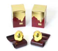 Two Risis models of eggs covered in 999 gold with wooden stands and boxed. (2) Please Note - we do