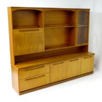 Vintage / Retro: A teak sideboard by Meredew, having fitted storage shelves within alcoves, a glazed