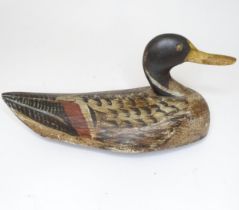 A hand carved and painted duck decoy, approx 12 3/4" long Please Note - we do not make reference