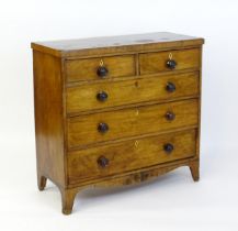 A 19thC mahogany chest of drawers comprising two short over three long drawers with turned knob