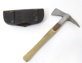 A Fireman's axe with leather head cover. Approx. 15 1/4" long Please Note - we do not make reference