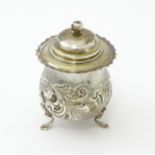 A silver pot and cover with embossed decoration hallmarked Birmingham 1904, maker RR. Approx. 4"