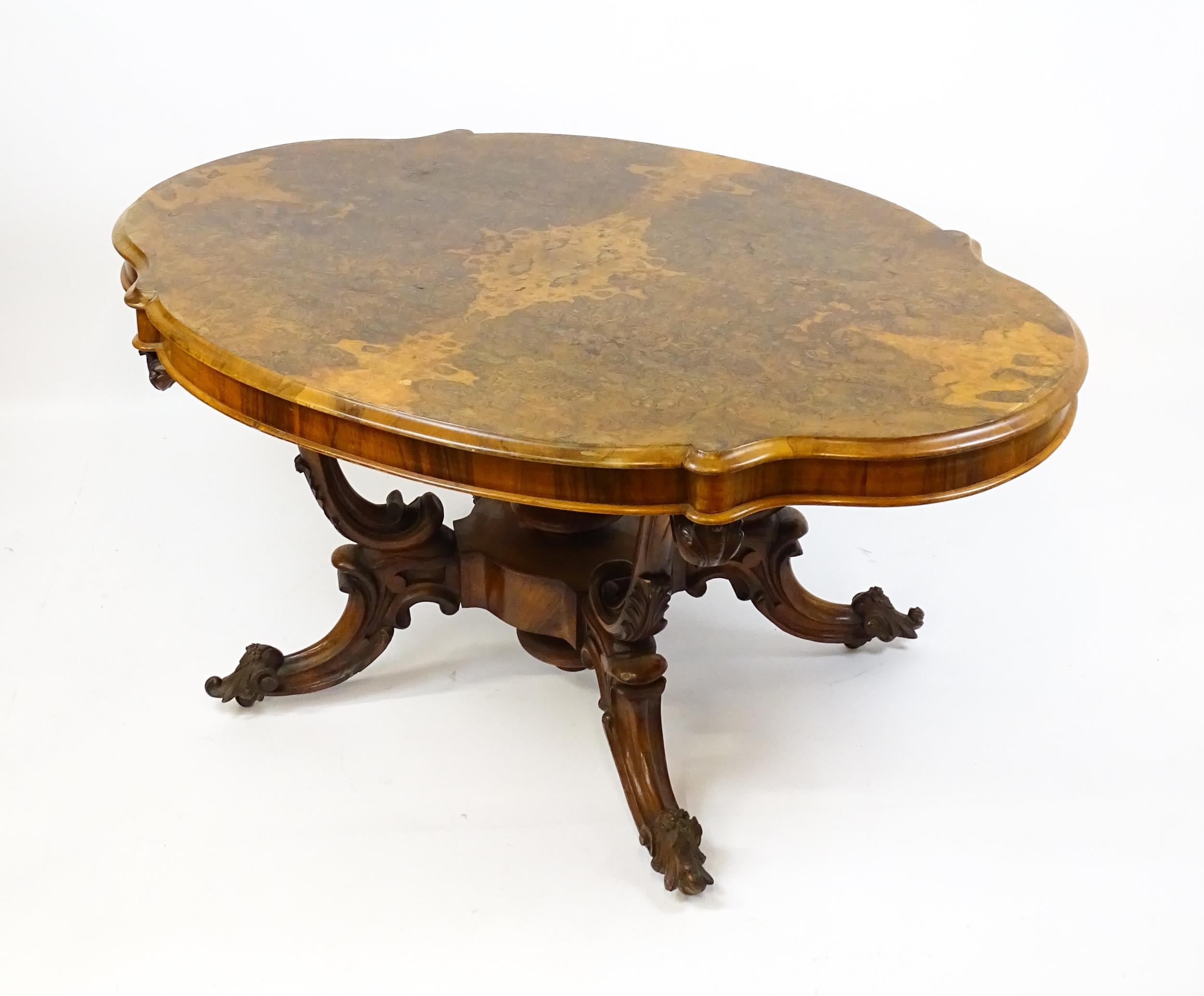 A 19thC burr walnut centre table with a moulded top above four acanthus carved supports, a large - Image 15 of 16