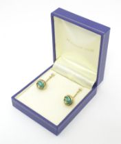 A pair of 9ct gold drop earrings set with turquoise. Approx 1 1/2" long Please Note - we do not make