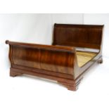 A modern mahogany sleigh bed. 6 1/2ft long x 5ft wide. Please Note - we do not make reference to the