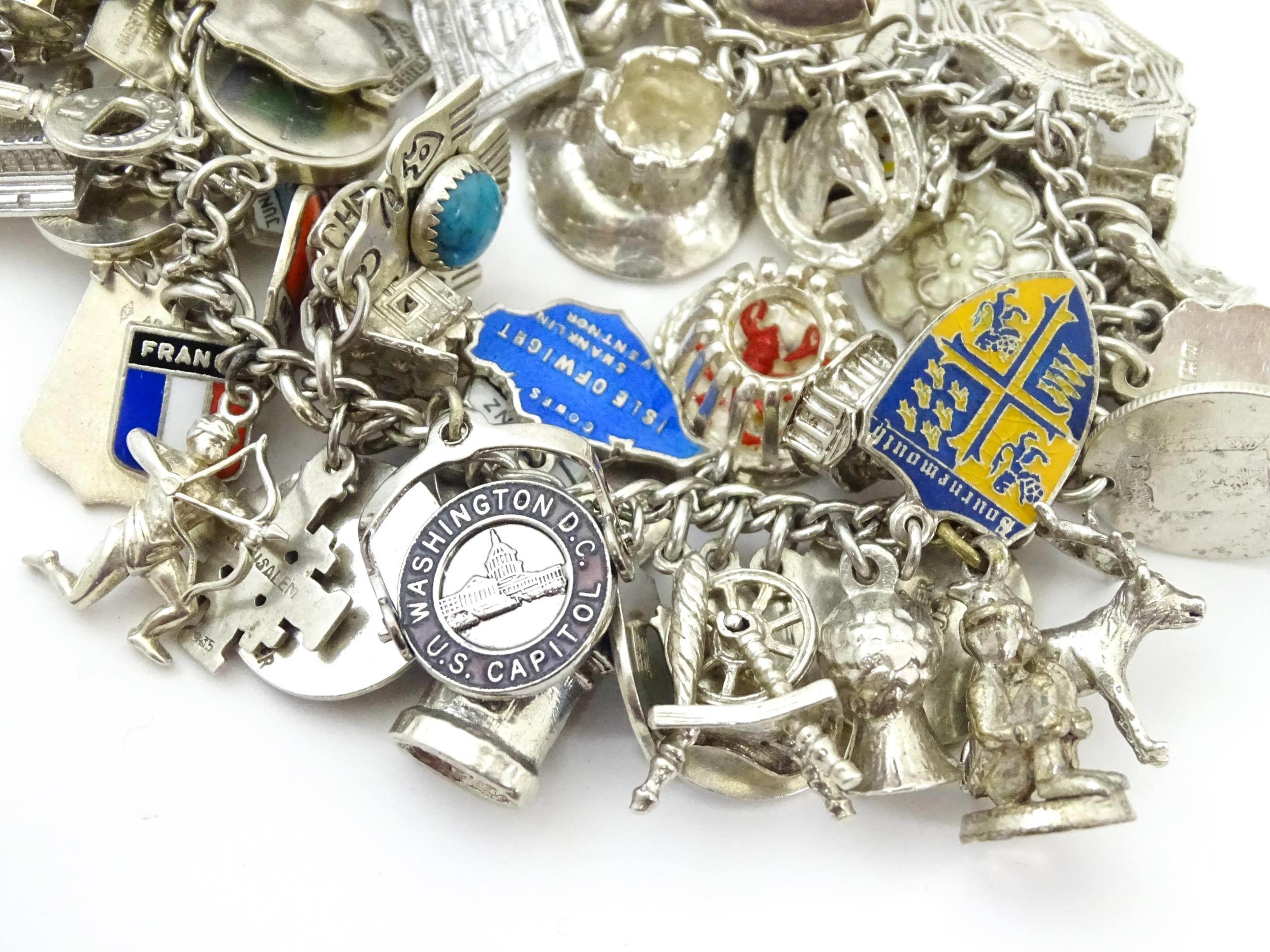 A silver charm bracelet set with various silver, white metal and silver plate charms Please Note - - Image 8 of 8