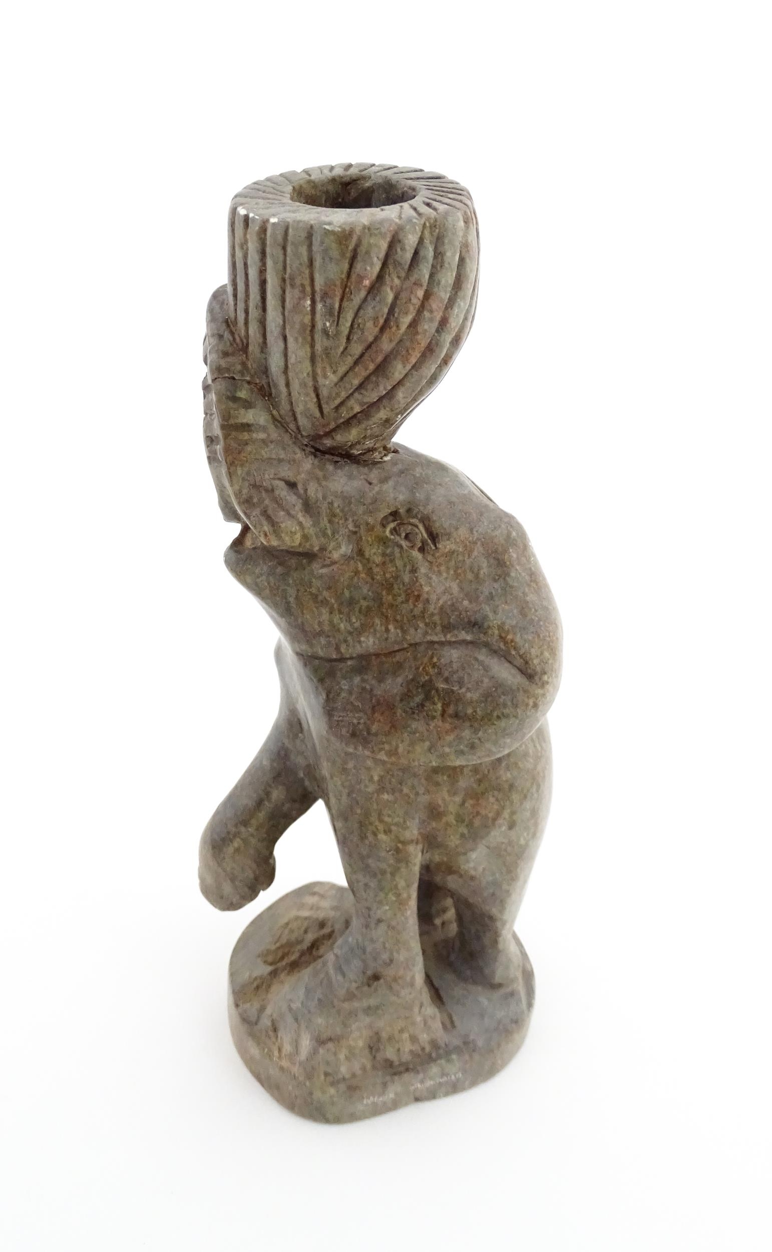 Ethnographic / Native / Tribal : An African carved soapstone candlestick formed as an elephant