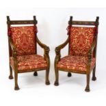 A pair of 19thC continental mahogany armchairs surmounted by corbel style reeded mounts and lions