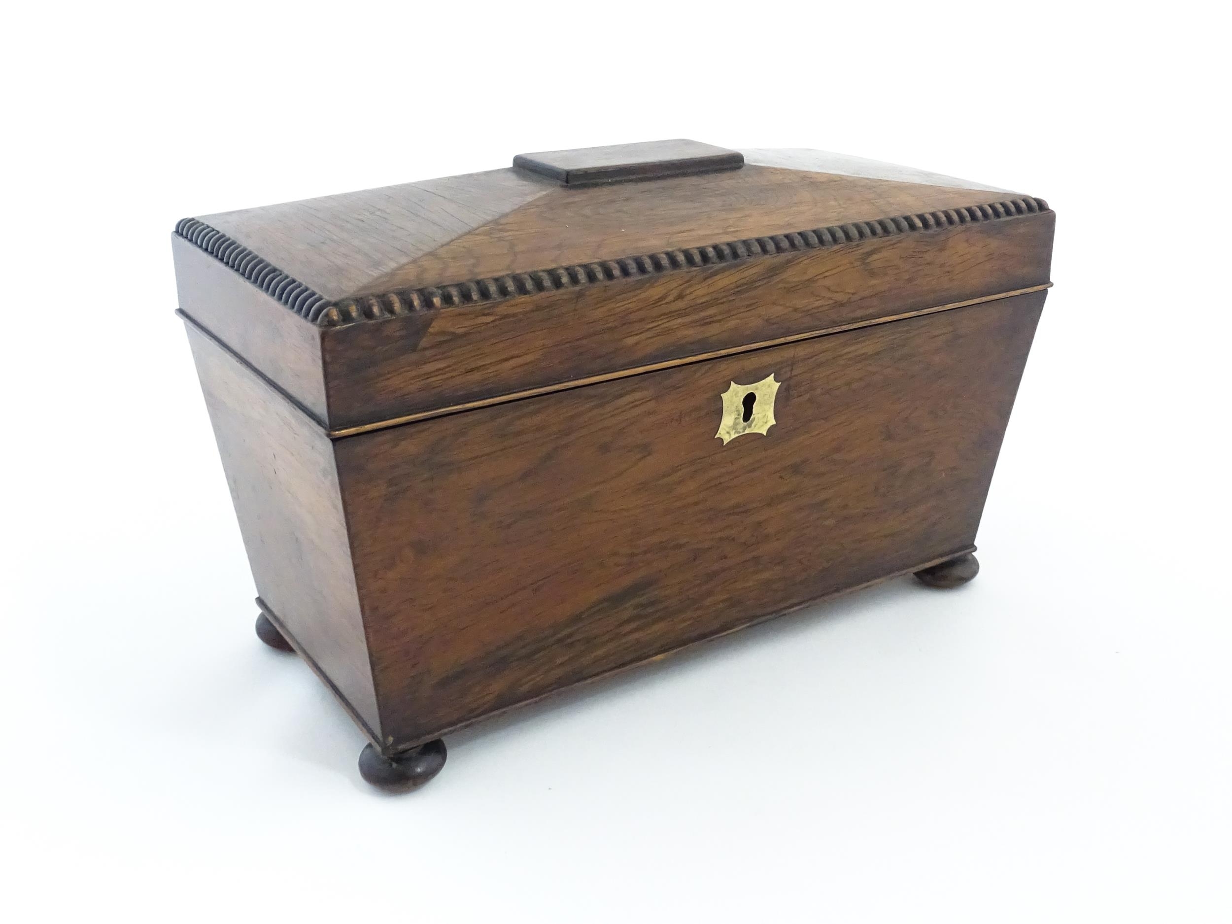 A 19thC rosewood tea caddy of sarcophagus form with four squat bun feet. The interior with two - Image 3 of 15