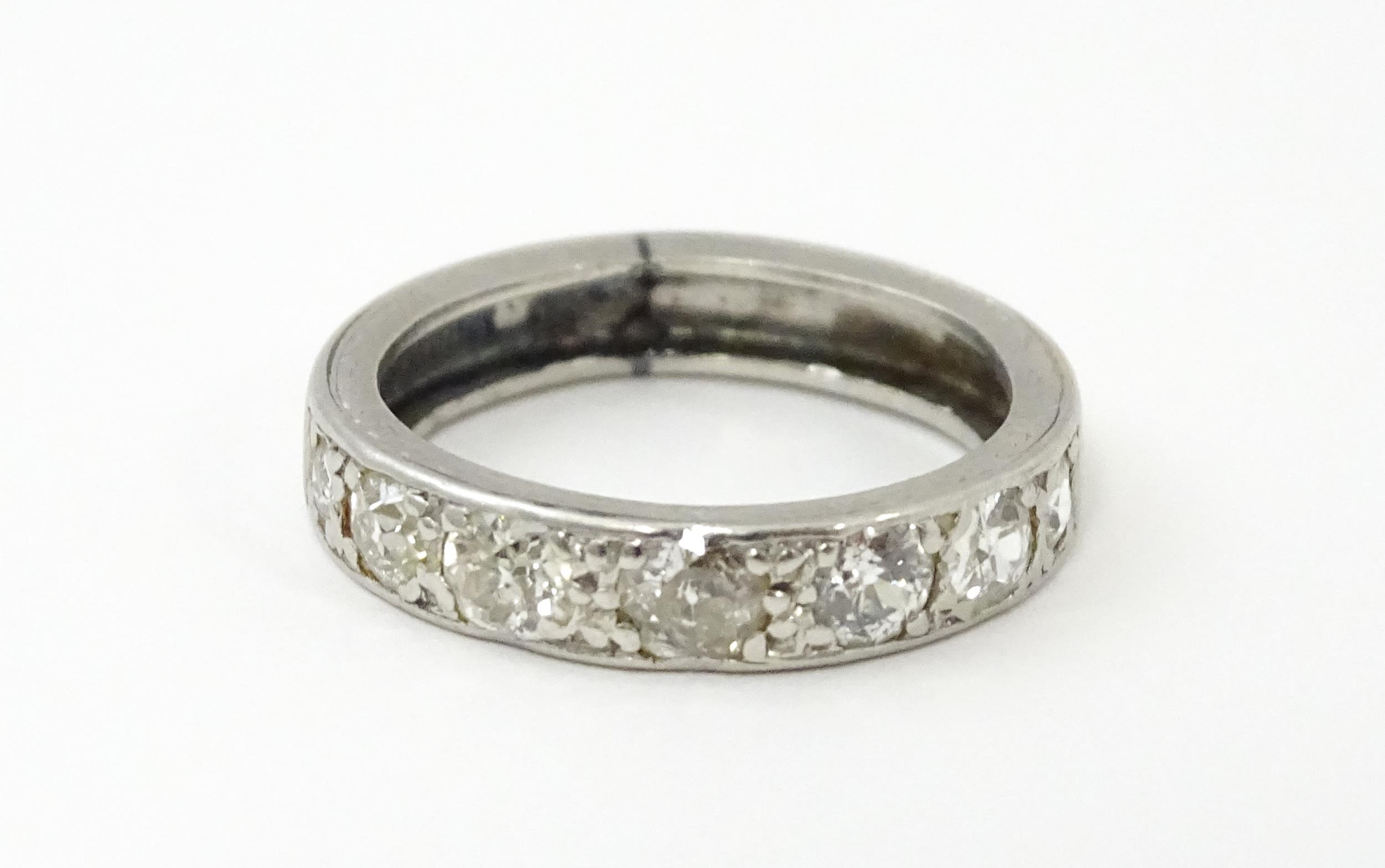 A diamond half eternity ring set with 7 diamonds. Ring size approx. L Please Note - we do not make